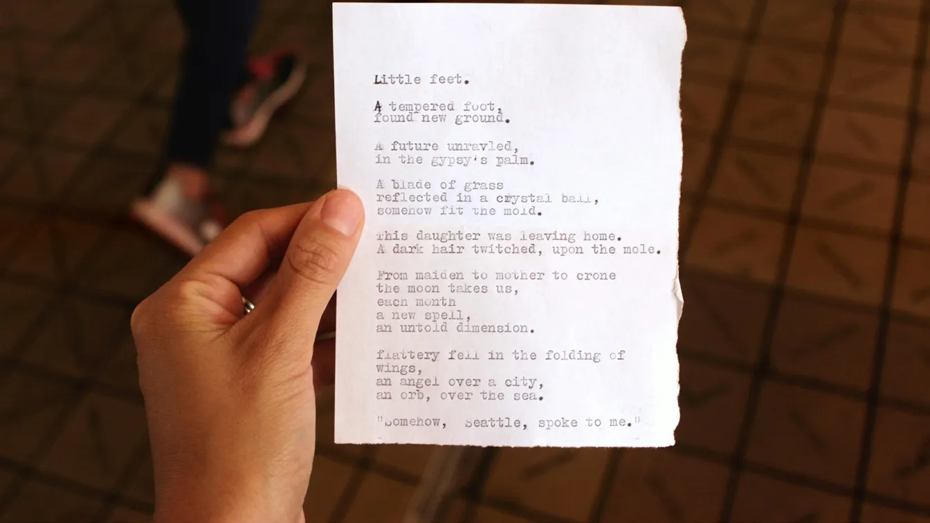 a person holding up a piece of paper with a poem on it