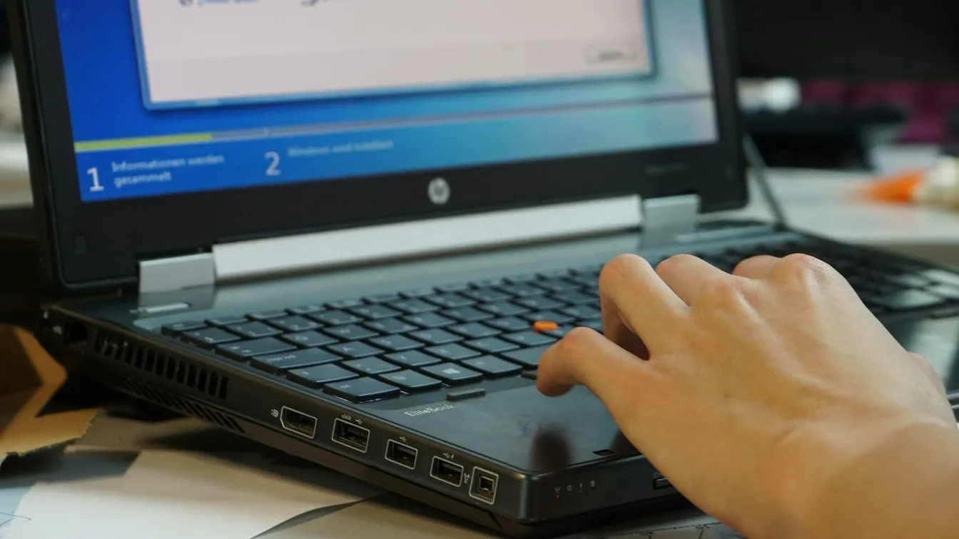 a person typing on a laptop computer